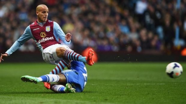 Willian (bottom) of Chelsea receives the first of his two yellow cards for this foul on Karim El Ahmadi of Aston Villa. The striker was sent off in the second-half.