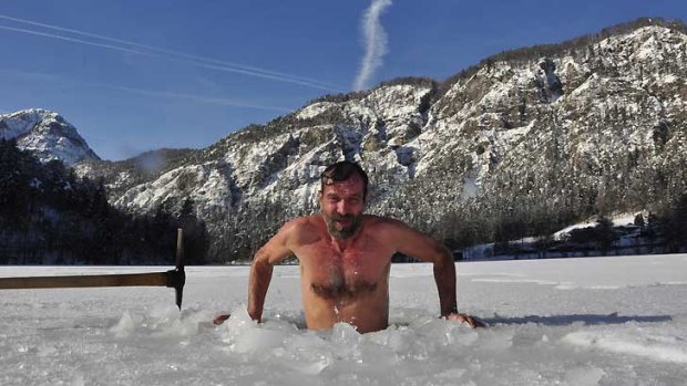 Wim Hof emerges from a frozen lake in the Spanish Pyrenees mountains.
