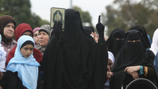 East meets west ... a woman addresses the rally in Lakemba yesterday. The crowd heard that more and more Western women are embracing Islam.