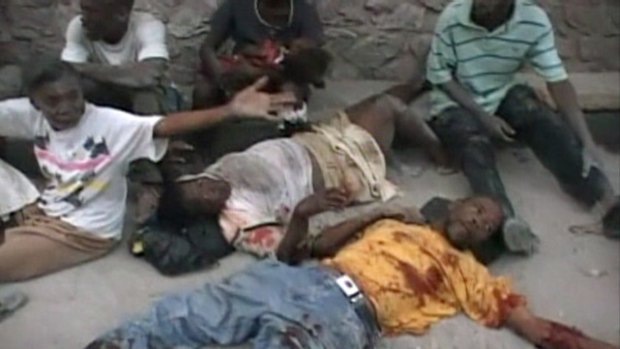 Earthquake victims lie on the ground in Port-au-Prince in this video grab.
