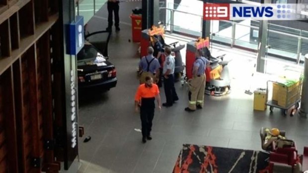 Emergency workers at the scene where a car crashed into the Gold Coast University Hospital foyer.