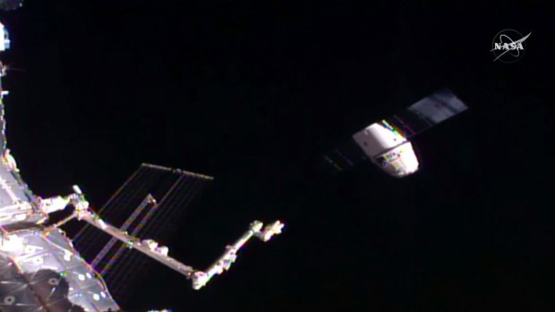 When things are working: in this frame grab taken from NASA Television, a SpaceX Dragon capsule, right, separates from a robotic arm of the International Space Station.