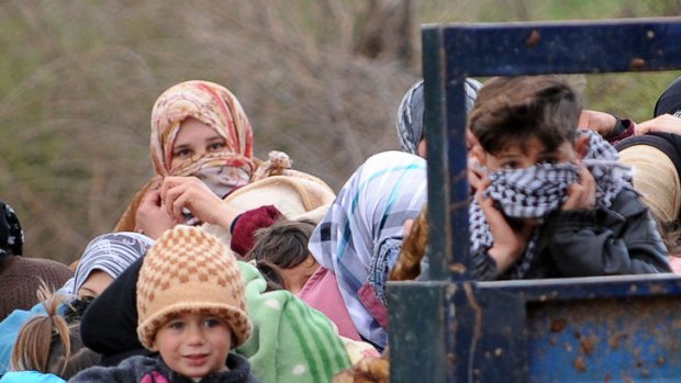 Syrian refugees arrive near the border between Syria and Turkey on Thursday.