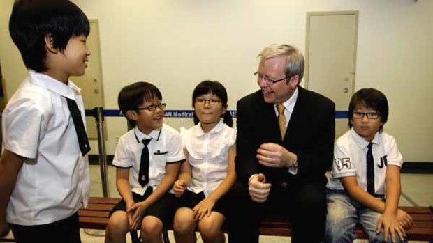 Kevin Rudd meets some of the children who have benefited from Cochlear hearing implants at Seoul's Asan Medical Centre.