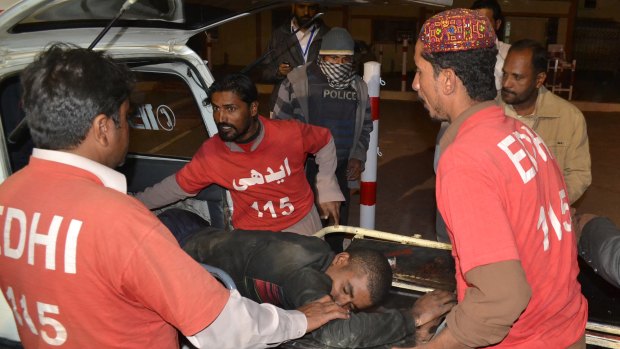 Pakistani volunteer medics rush an injured person to a hospital in Quetta after an attack last week.