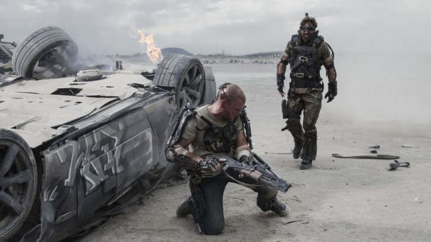 Matt Damon (left) and Sharlto Copley in <i>Elysium</i>.