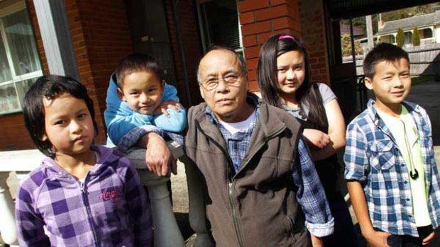 Sixty-year-old learner Moo Die Chit, with his children.
