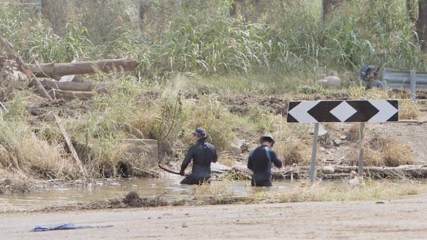 Seeking closure ... police divers continue the search for bodies in Grantham on January 18.