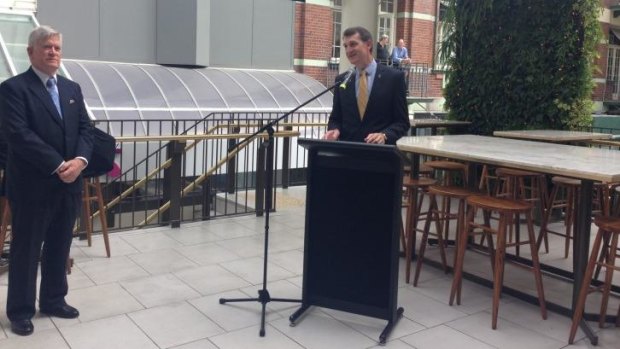 Brisbane Lord Mayor Graham Quirk, watched by Mantle Group director Godfrey Mantle, officially opens the relocated city institution Jimmy's on the Mall, 10 days ahead of the G20 summit.