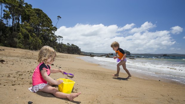 Maddy, 2, and Casey Matthews-James, 4, of Buckhurst Hill England enjoy a beautiful day at the beach in Batemans Bay.