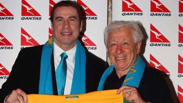 Celebrity fan ... John Travolta  is presented with a Socceroo team shirt by Football Federation Australia Chairman Frank Lowy