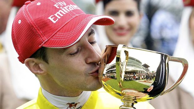 French jockey Christophe Lemaire kisses the cup after winning the 2011 Melbourne Cup on French stayer Dunaden in a photo-finish with English stayer Red Cadeaux.