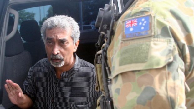 Former prime minister Mari Alkatiri, flanked by Australian soldiers in July  2006.