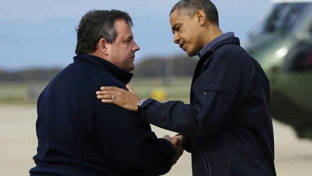 Surverying the damage ... Barack Obama is greeted by New Jersey Governor Chris Christie.