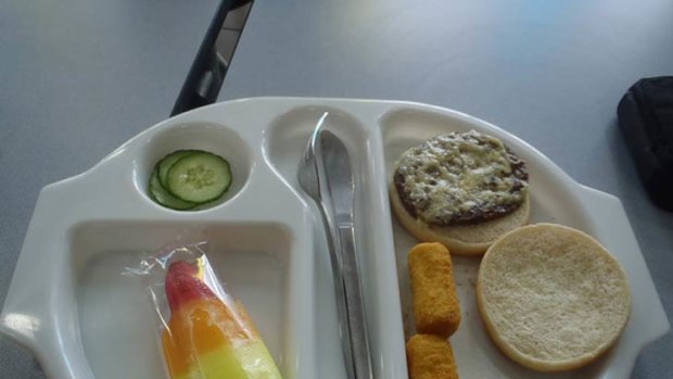Uninspiring school lunch? ... two croquettes, a plain cheeseburger, three slices of cucumber and a lollipop.