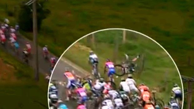 Tour tangle ... Simon Gerrans, with his legs in the air, crashes into a barbed wire fence in a bruising third stage.
