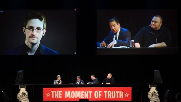 NSA whistleblower Edward Snowden (left) speaks via video link to an Internet Party event in Auckland on Monday.