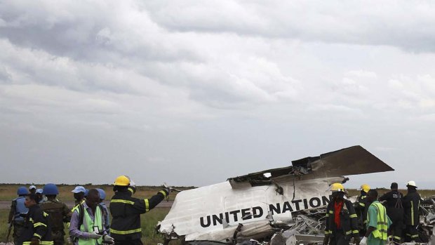 Salvage workers gather at the scene of a United Nations plane crash in Kinshasa, capital of the Democratic Republic of Congo.