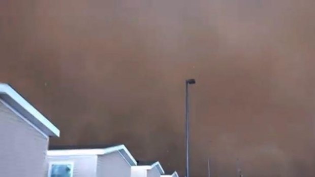 The tornado, filmed by oil worker Dan Yorgason, turns the sky dark.