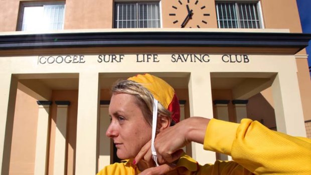 Trusted since 1930 ...  Amy Teale, of Coogee surf club, dons the much-loved red and yellow cap.