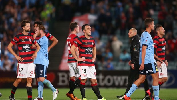 Feeling the pain: Wanderers players feel the dejection of a dropped point against their rivals.