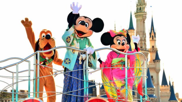 East meets West ... Mickey and Minnie Mouse in kimonos, with Pluto, at Tokyo Disneyland.