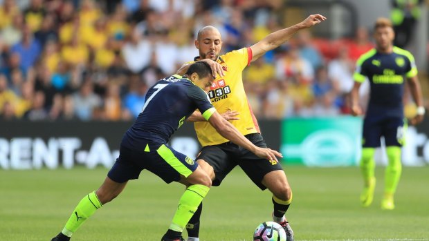 Arsenal's Alexis Sanchez and Watford's Nordin Amrabat compete for the ball.