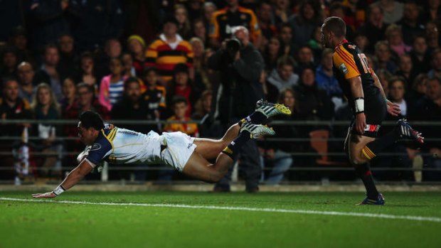 Brumbies centre Christian Lealiifano dives over to score before half-time in the Super Rugby final.