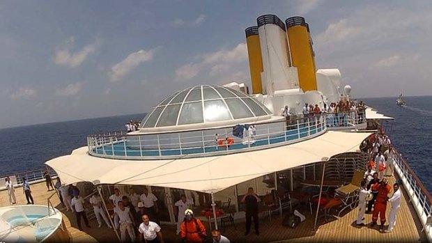 A still image taken from a video footage shows the Costa Allegra cruise ship being towed by French tuna boat Trevignon in the Indian Ocean.