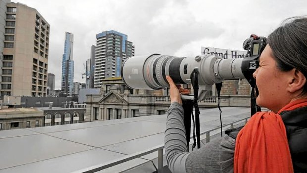 The Age photographer Penny Stephens stands on a balcony at Media House and photographs Eureka Tower.  The building is approximately the same distance as the photographer who captured photographs of a topless Kate Middleton.