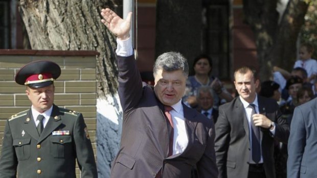Ukrainian President Petro Poroshenko waves to cadets in Kiev.