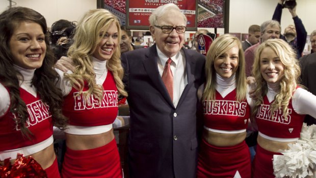 The Sage of Omaha: Berkshire Hathaway chairman and chief executive Warren Buffett poses with University of Nebraska cheerleaders.