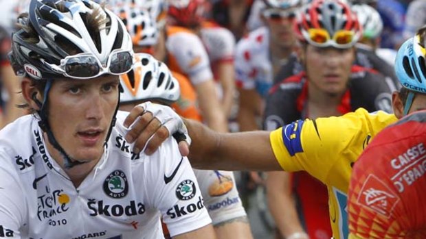 Conciliatory gesture . . . Alberto Contador (obscured) places his hand on the shoulder of former race leader Andy Schleck.