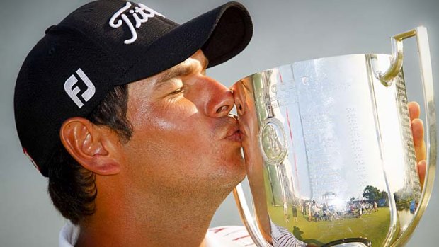 Roughie .. Daniel Popovic smooches the cup after winning the Australian PGA Championship.