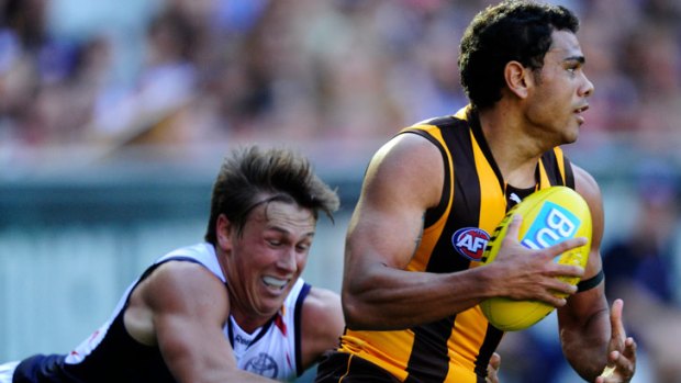 Hawthorn's Cyril Rioli is chased by Adelaide's Brodie Martin.