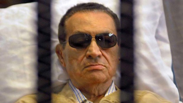 Hosni Mubarak in the defendant's cage as a judge reads the verdict on charges of complicity in the killing of protesters.