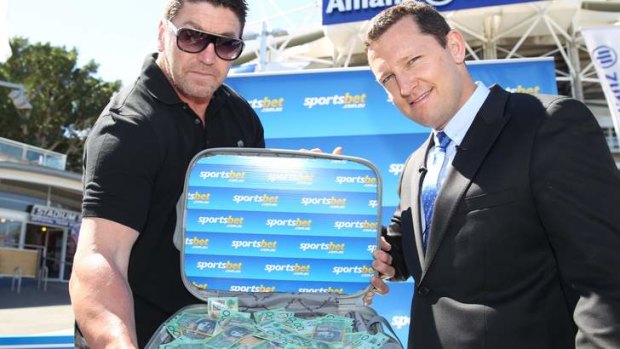 Cashed up: Mark ''Spud'' Carroll holds the $100,000 Joel Caine revealed Sportsbet would pay to a charity if the premier comes from outside the NRL top four.