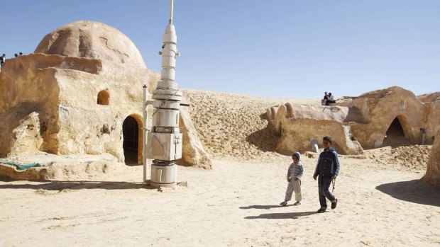 Local boys sell traditional souvenirs in the Star Wars movie set in the Ong Jmal, in the Nefta, south of Tunisia.