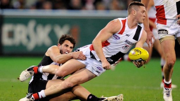 St Kilda's Jack Steven is tackled by Magpie Alex Fasolo last night..