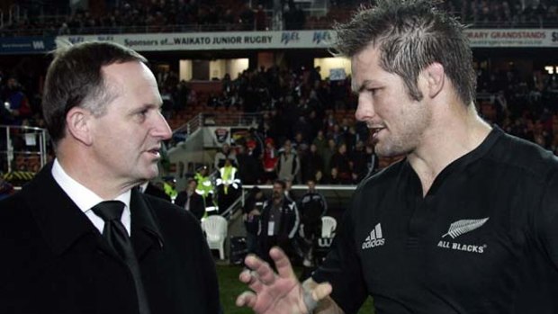 Who has the most important job? All Blacks captain Richie McCaw (R) talks to New Zealand's Prime Minister John Key.
