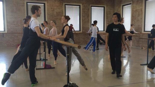 Queensland Ballet artistic director Li Cunxin walks American dancers James Whiteside and Gillian Murphy through a class in Brisbane.