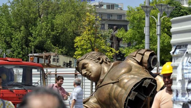 Like a Greek - or Macedonian - god ... construction of the contentious monument gets under way.
