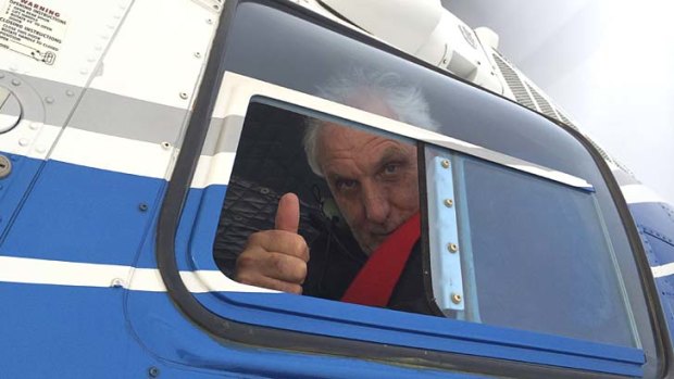 Thumbs up: Phillip Noyce aboard a helicopter filming <em>The Giver</em> in Utah, which stars Meryl Streep, Jeff Bridges, Katie Holmes, Taylor Swift, Brenton Thwaites and Alexander Skarsgard.
