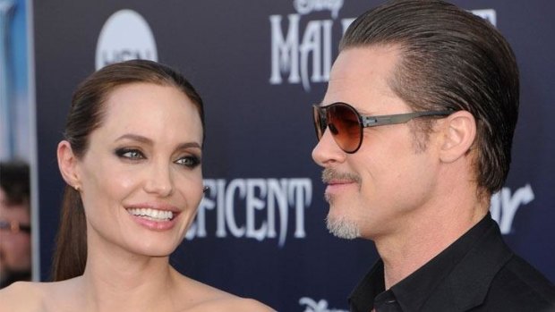 Serial pest Vitalii Sediuk jumped over a barricade and allegedly struck Brad Pitt, seen here with his partner Angelina Jolie, on the face at the Maleficent premiere.