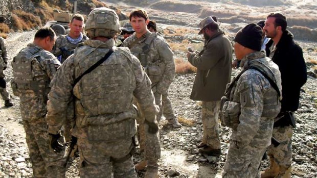 William Swenson, centre facing camera, in Afghanistan before the the deadly firefight. Beside him wearing a helmet is Kenneth Westbrook who died as a result of the battle.
