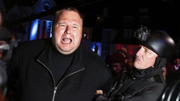 Publicity stunts: An actor in police costume mock-arrests Kim Dotcom during a press launch for Megaupload. 