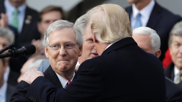 'What a job': President Donald Trump greets Senate Majority Leader Mitch McConnell after the latter heaped praised on his efforts to date.
