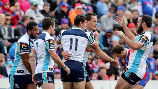 Downer: Titans players celebrate a try against the Knights.