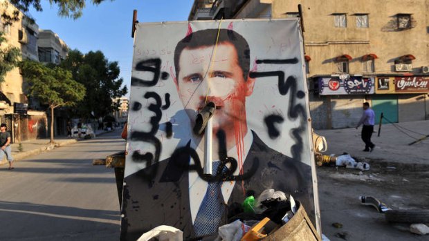 A vandalised poster of Syrian President Bashar al-Assad.