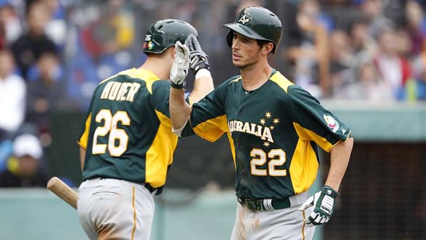 Australia's Stefan Welch (right) celebrates with teammate Justin Huber after hitting a home run against Taiwan.